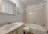 Bright and inviting bathroom with modern fixtures, elegant vanity, and a relaxing bathtub.