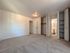 Bright and spacious bedroom with plush carpet, ample closet space, and an attached bathroom for convenience and comfort.
