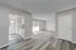 Bright and airy open-concept living space with modern kitchen and stylish flooring, perfect for contemporary living.