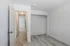 Bright and inviting hallway with modern light wood flooring, leading to spacious rooms in a stylish apartment.