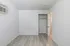 Bright and spacious bedroom with elegant flooring and ample closet space, perfect for a serene living environment.