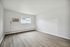 Bright room with large window and sleek floor, perfect for a customizable living space.
