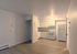 Modern apartment kitchen with sleek white cabinetry, spacious counter space, and integrated appliances.