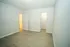 Bright and airy room featuring elegant wood-style flooring, freshly painted walls, and a spacious closet entrance.