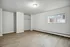 Bright, spacious room with sleek wood flooring and a large window bringing in natural light.
