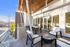 Rooftop social space with outdoor seating and a cozy fire pit