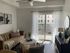 Living room with large windows and a patio showcasing views