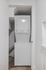 Compact laundry area featuring a sleek, white stacked washer and dryer, optimizing space in a modern apartment.