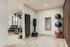 Modern apartment gym with sleek equipment, free weights, and vibrant yoga balls on wooden flooring.