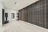 Sleek exercise room with modern decor, featuring a wooden slatted wall, mirrored surface, and vibrant fitness balls for a dynamic workout experience.