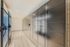 Sleek package locker and modern snack vending area in a bright, contemporary apartment complex hallway.
