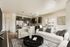 Modern open-concept living area with elegant kitchen, stylish furnishings, and natural light-filled space.