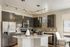 Modern kitchen with sleek stainless steel appliances, glossy cabinets, and an elegant island, ideal for both cooking and entertaining.