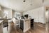 Modern open-concept apartment with elegant kitchen island, cozy living area, and large windows showcasing urban views.