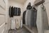 Elegant walk-in closet featuring organized racks of neatly arranged clothing and ample storage space.