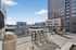 Chic urban terrace with modern seating and stunning cityscape views, ideal for entertaining.