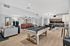 Modern community lounge featuring a sleek pool table, cozy seating, and a spacious kitchen area with chic bar stools.