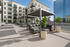 Luxurious outdoor terrace featuring modern seating under stylish pergolas, surrounded by lush potted plants and offering stunning city views.
