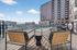 Modern rooftop view with stylish poolside loungers and scenic cityscape backdrop.