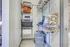 Modern walk-in closet with organized shelves, stylish pillows, and ample hanging space for a clutter-free living experience.