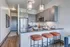 Chic modern kitchen featuring sleek cabinetry, stainless steel appliances, and a stylish breakfast bar with elegant lighting.