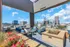 Luxurious urban terrace with elegant seating and vibrant cityscape views, perfect for relaxing and entertaining.