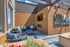 Stunning rooftop patio featuring modern wood paneling, plush blue seating, and vibrant outdoor artwork, perfect for relaxation.