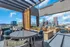 Chic rooftop terrace offering stylish seating and vibrant cityscape views, perfect for relaxing in urban elegance.