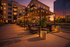 Luxurious outdoor lounge area with modern pergolas and cozy seating, beautifully lit against a stunning sunset backdrop.