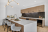 Sophisticated modern kitchen with sleek wooden cabinetry, stylish marble island, and elegant lighting fixture.