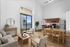Bright, modern open-concept living and dining area featuring sleek hardwood floors, elegant wooden furniture, and a well-appointed kitchen with stainless steel appliances.