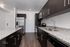 Modern kitchen design with sleek dark cabinetry, stainless steel appliances, and elegant granite countertops.