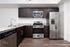 Modern kitchen with sleek dark cabinetry, stainless steel appliances, and granite countertops, offering a stylish and functional space.