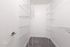 Spacious walk-in closet with modern wire shelving, ideal for organized storage in a luxurious apartment.