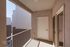 Charming apartment balcony with modern railing and sleek exterior design, offering a private outdoor retreat.
