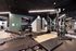Modern fitness center with state-of-the-art exercise equipment, including weights and benches, in a stylishly designed room.