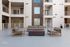 Chic apartment balcony featuring modern outdoor seating and sleek railings, perfect for relaxation and entertainment.