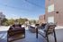 Chic outdoor terrace with modern seating, perfect for relaxation and social gatherings, featuring stunning cityscape views.