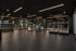 Modern fitness center with state-of-the-art equipment including treadmills, weight racks, and exercise bikes, set in a sleek and spacious environment.