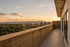 Breathtaking apartment balcony with panoramic city view at sunset, showcasing a perfect blend of urban living and natural beauty.