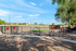 Inviting pet-friendly outdoor area with vibrant play equipment perfect for your furry friends, set against a sunny backdrop.