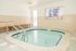 Inviting indoor spa with soothing warm waters and modern design, perfect for relaxation and wellness.