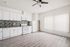 Modern kitchen with sleek white cabinetry, stylish backsplash, and energy-efficient appliances in a bright, airy space.