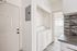 Bright and modern laundry area with sleek cabinetry, featuring a washer and dryer next to a stylish backsplash.