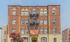 Charming Tudor-style apartment building with vibrant brickwork and inviting street appeal.