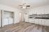 Bright and modern kitchen with sleek white cabinets, elegant tile backsplash, and in-unit washer and dryer setup for convenience.