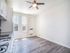 Bright and airy kitchen with modern finishes, sleek cabinetry, and large windows inviting natural light, perfect for a cozy culinary experience.