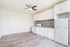 Modern kitchen with sleek white cabinetry, stylish backsplash, and stainless steel appliances in a bright, open space.