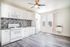 Bright modern kitchen with sleek white cabinetry, stylish tile backsplash, and a spacious open layout featuring stainless steel appliances and elegant wood flooring.