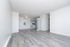 Bright and airy open-concept living area with modern kitchen, featuring elegant light wood flooring and stylish cabinetry.